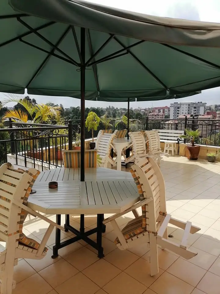 Rooftop terrace with dining setup and city panorama