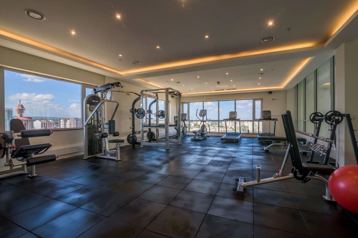 High-rise gym with cardio equipment and city skyline views