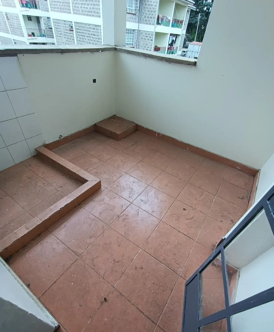 Small kitchen with terracotta tile flooring, under renovation