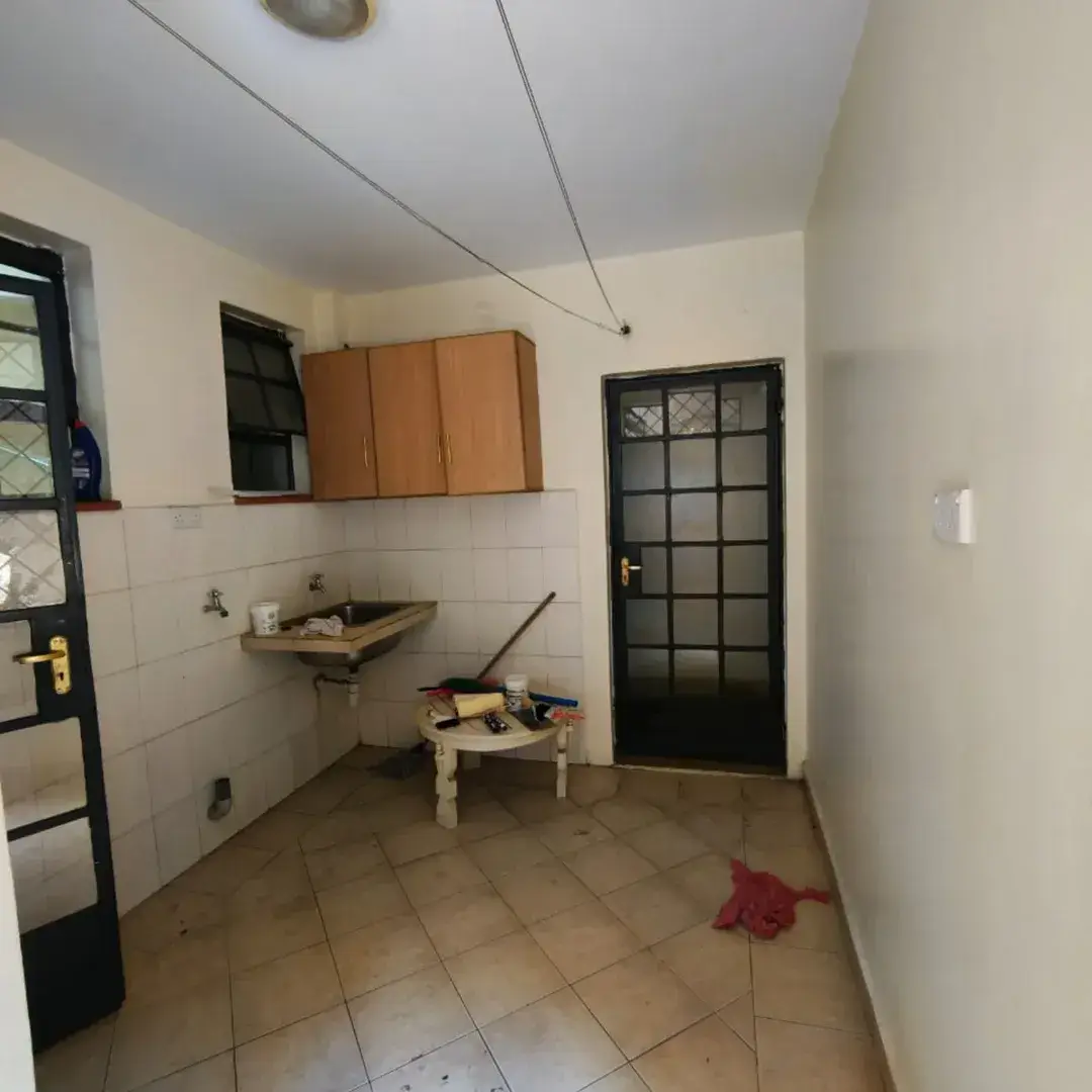 Compact kitchen with wall-mounted cabinets and basic sink
