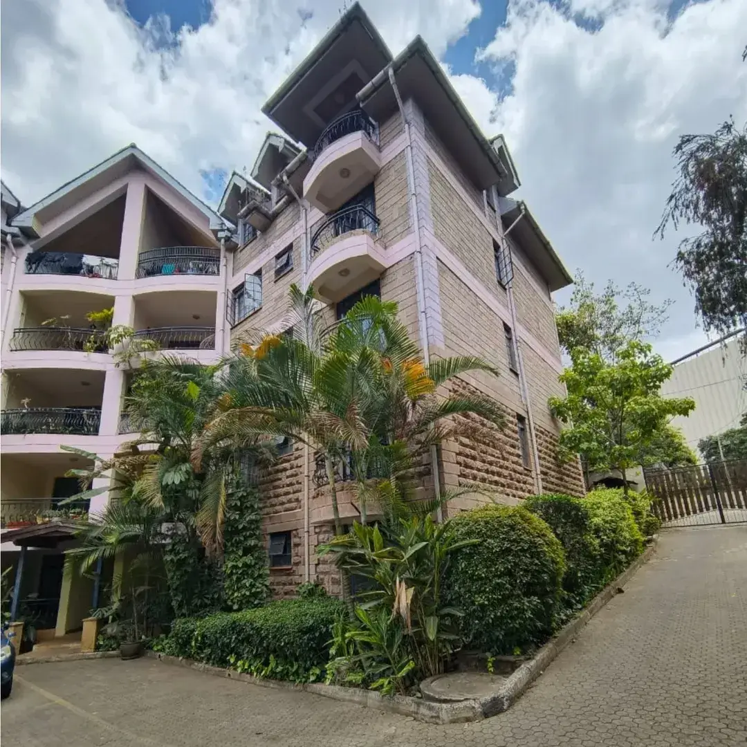Modern multi-story residential building with manicured gardens