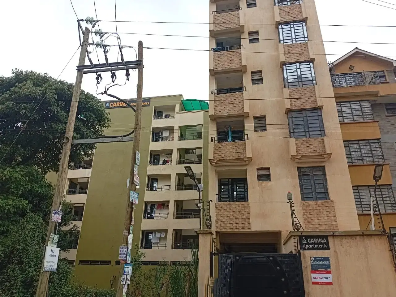 Multi-story residential building facade with balconies and ground-level shops