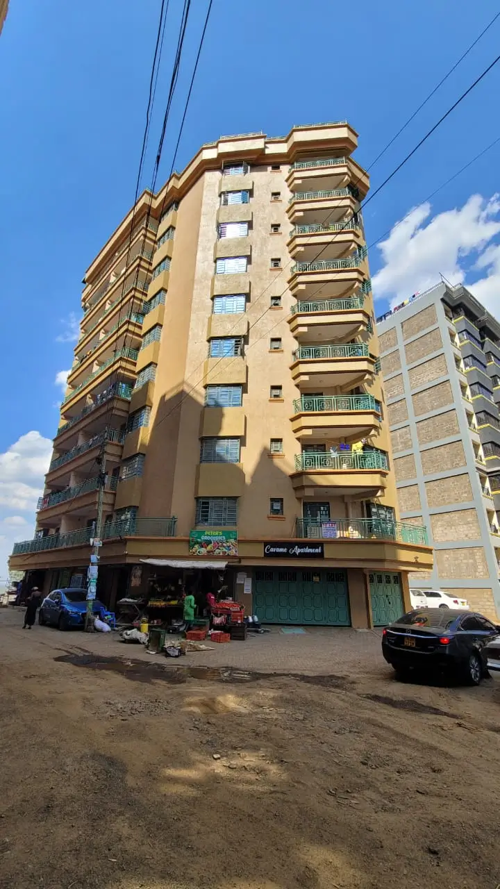 Multi-story residential building facade with balconies and ground floor retail