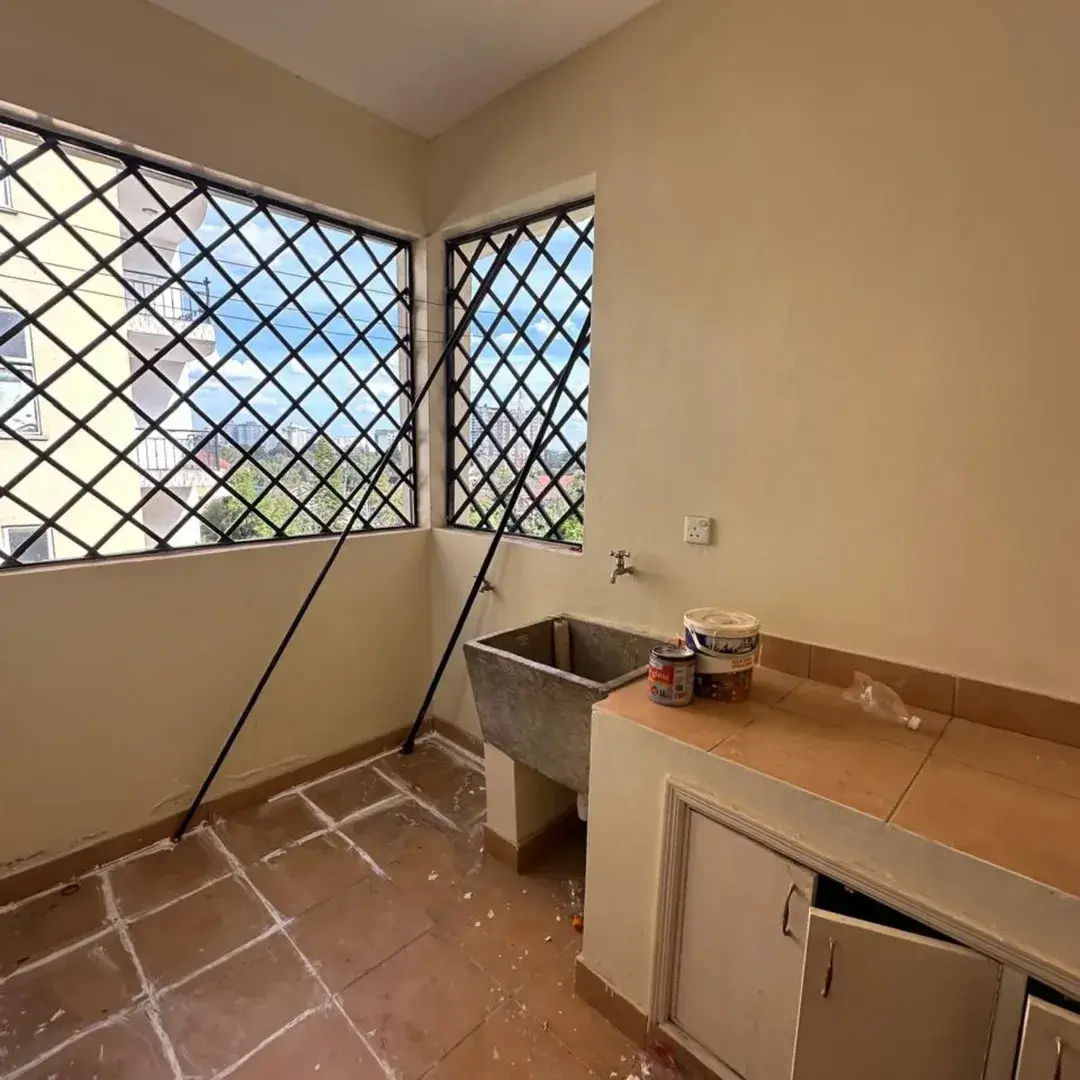 Kitchen with sink and counter, laundry basin visible