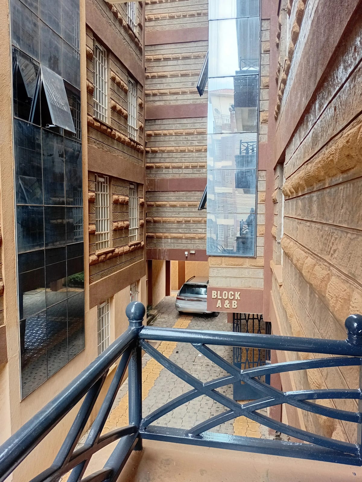 Balcony overlooking urban courtyard with surrounding brick buildings