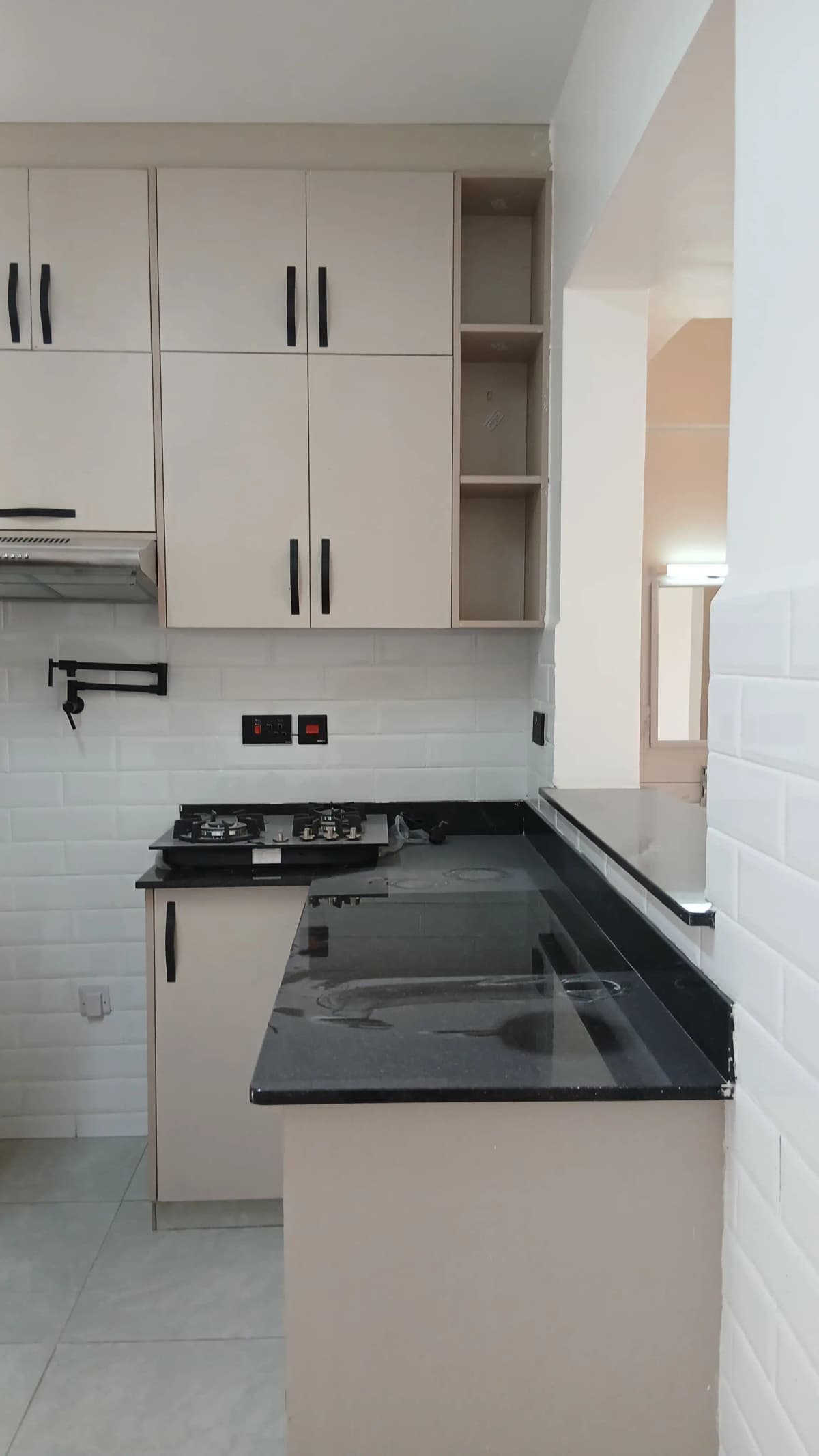 Modern kitchen with black countertops and cream cabinetry