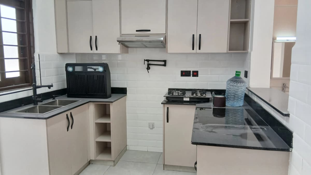 Modern kitchen with black countertops and white cabinetry