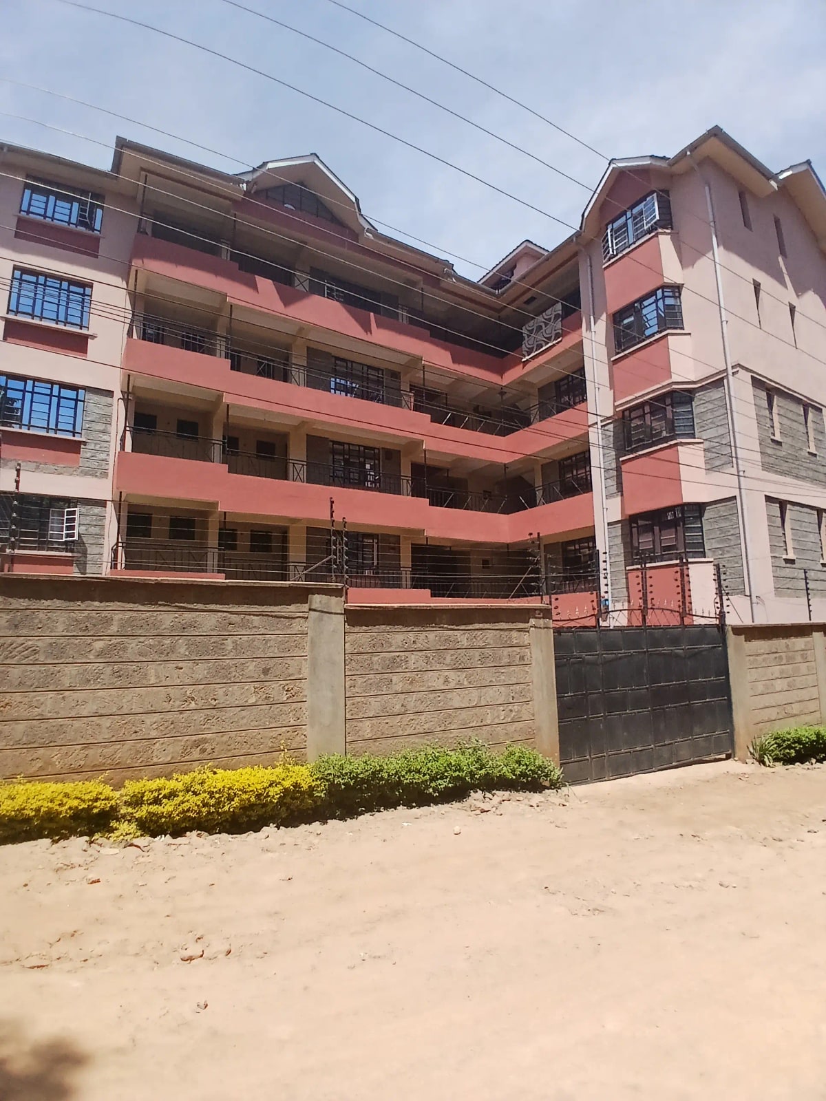 Multi-story residential building with pink and cream facade