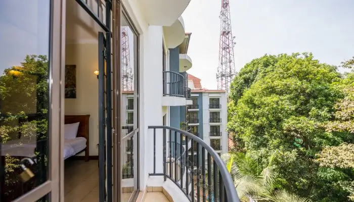 Modern balcony with metal railing overlooking green surroundings