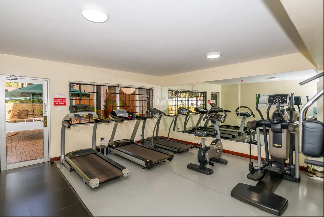 Well-equipped fitness room with treadmills and exercise bikes