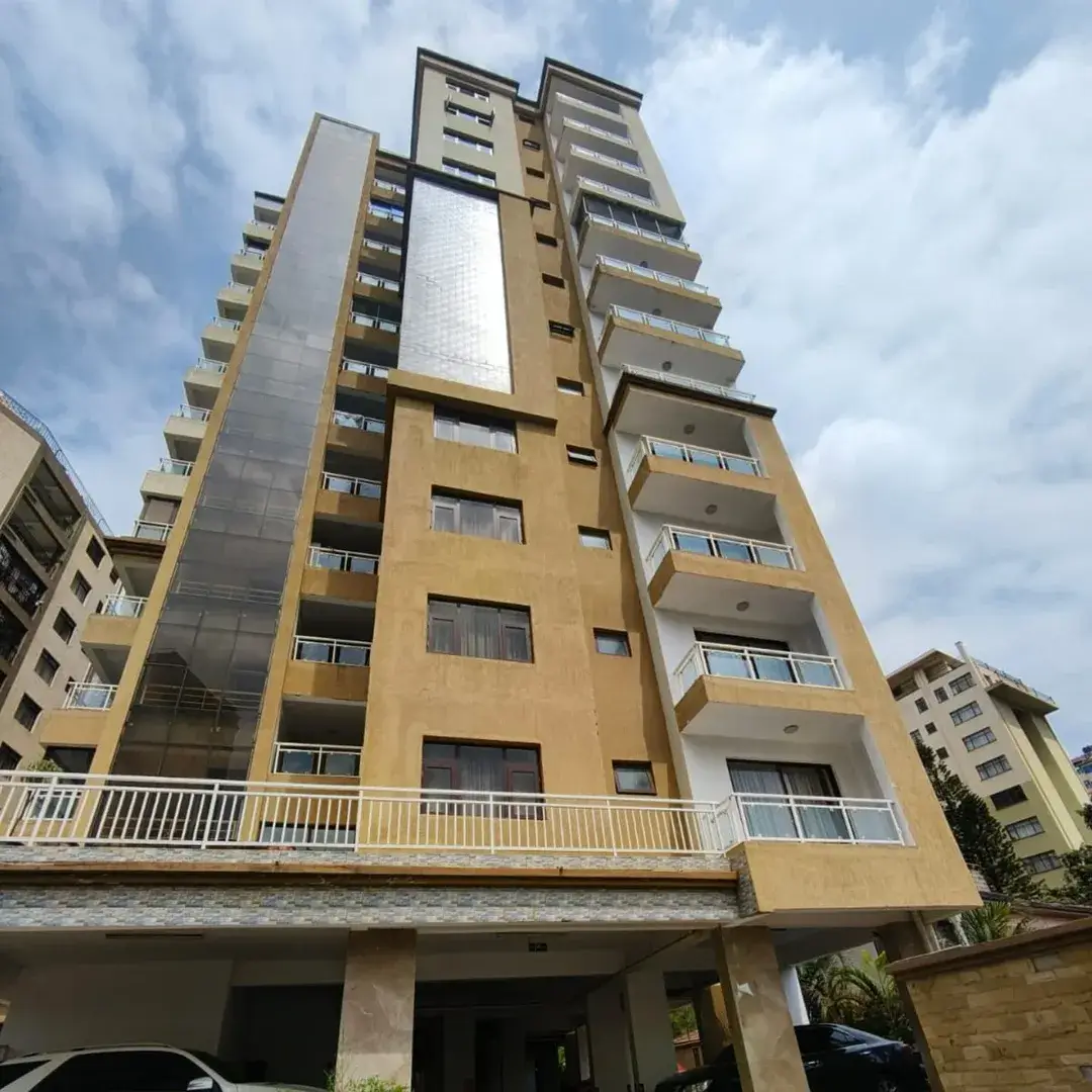 Multi-story residential apartment building with yellow facade