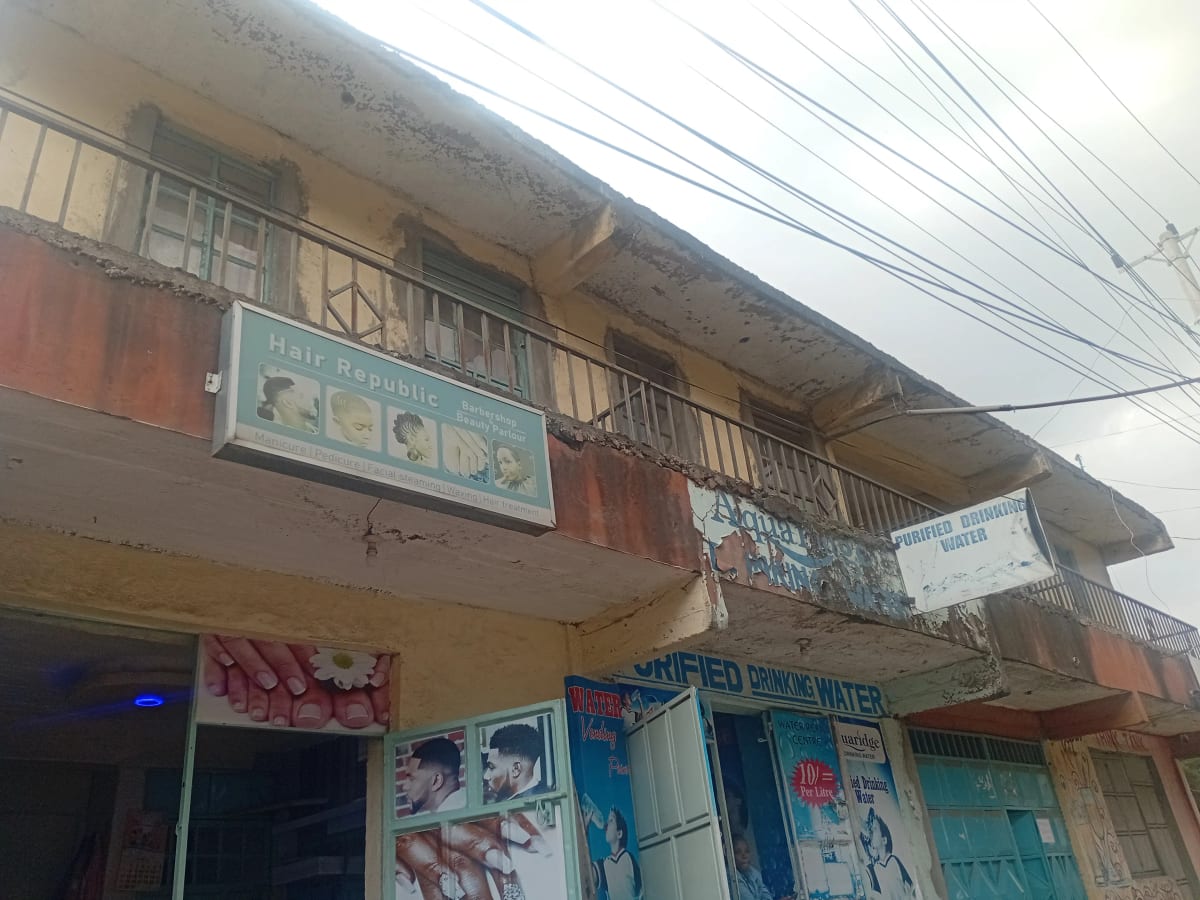 Weathered multi-story residential building facade with signage