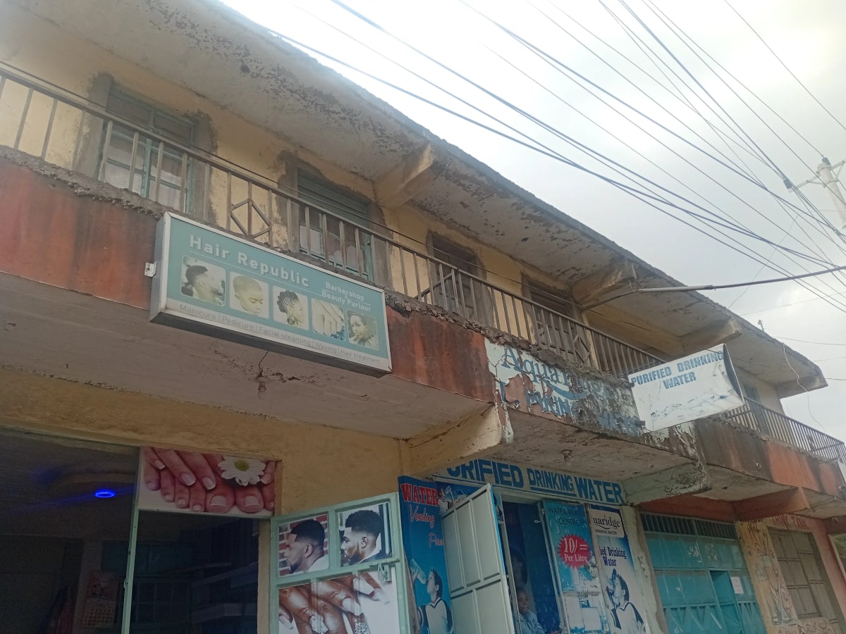 Weathered multi-story residential building facade with signage