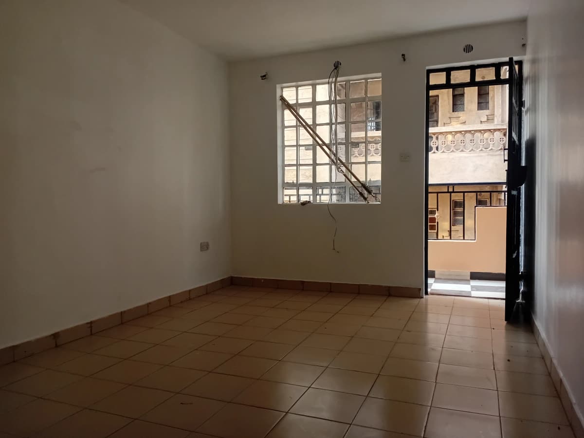 Empty living room with tiled floor and street view door