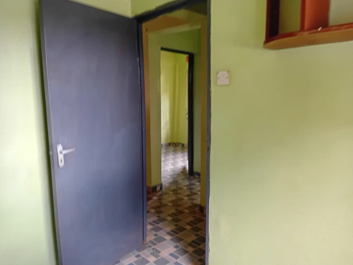 Interior corridor with blue door and tiled flooring
