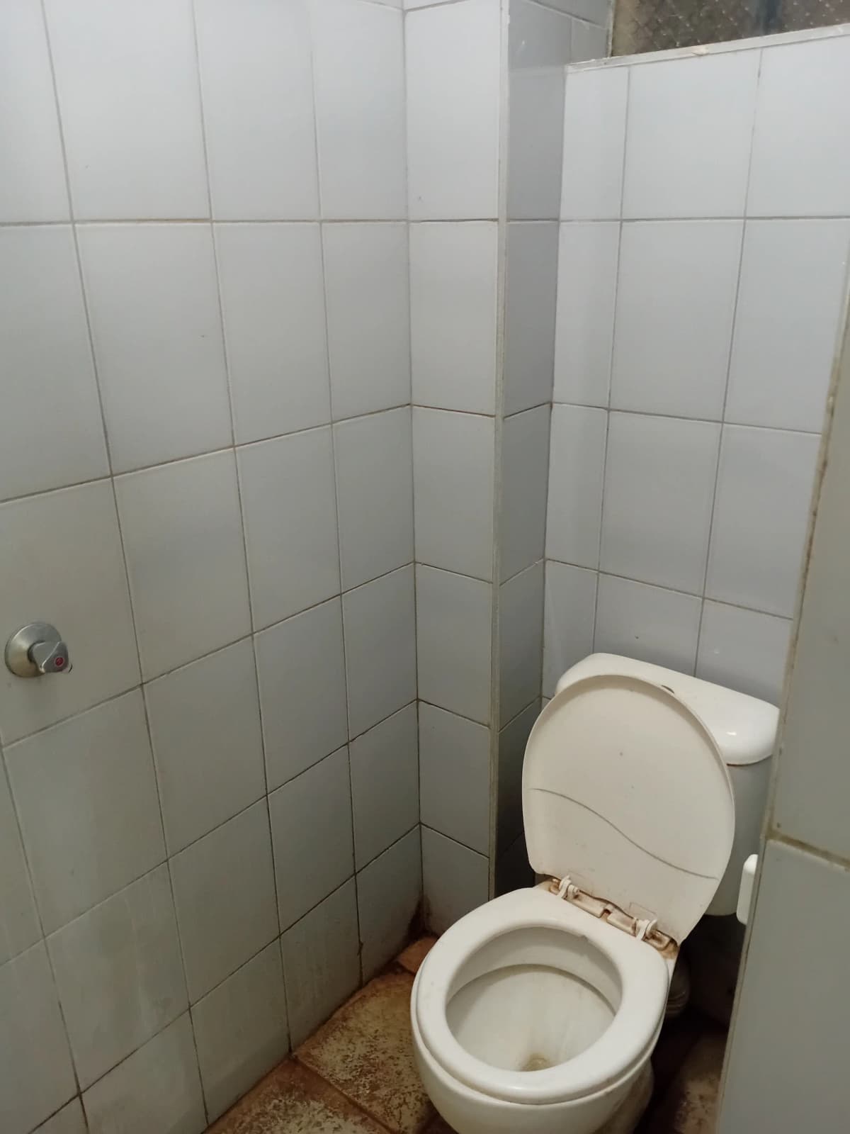 Basic bathroom with white tile walls and toilet