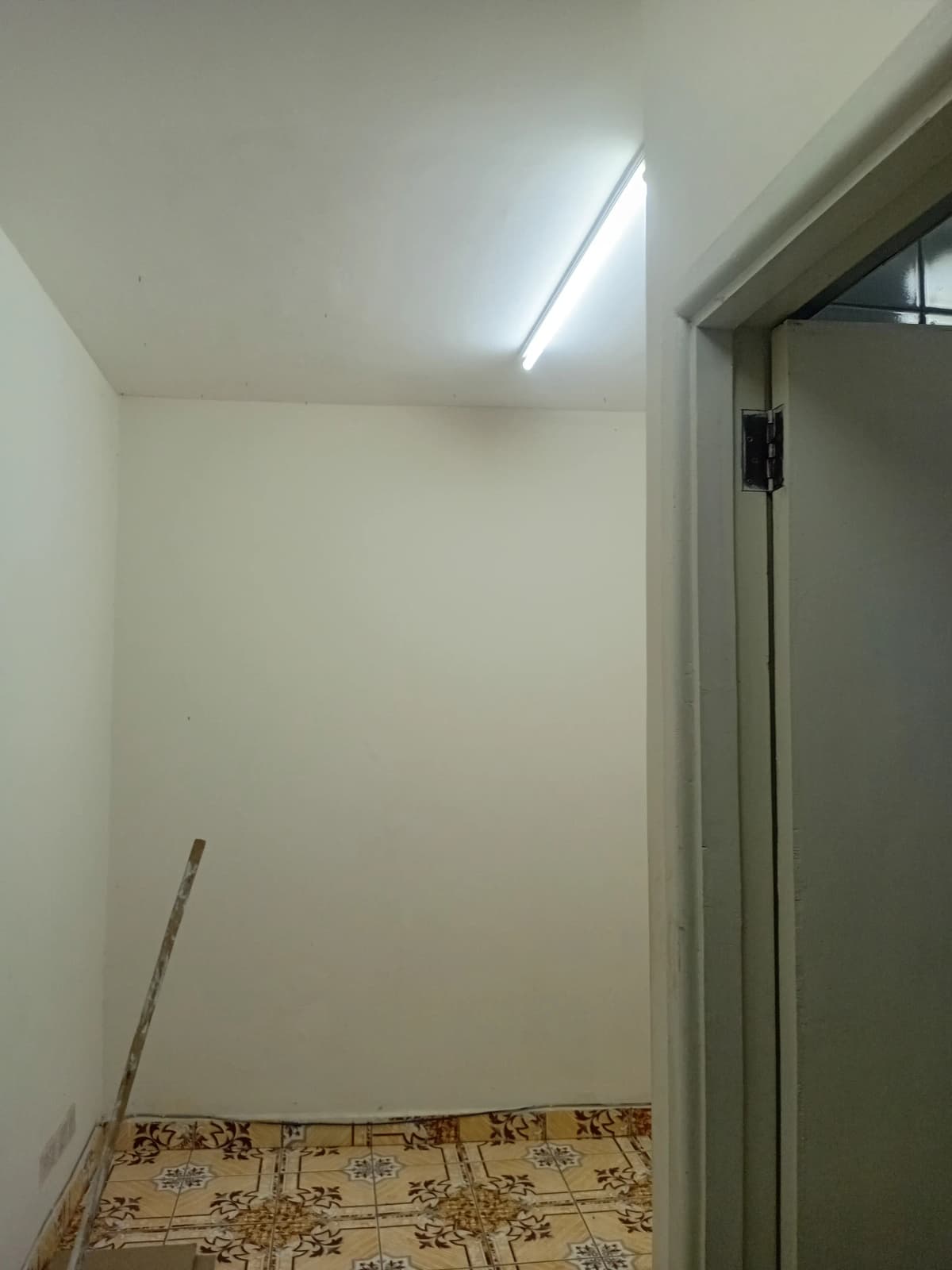 Narrow corridor or hallway with skylight and closed door