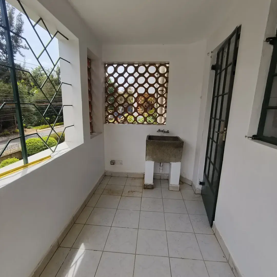 Bright corridor with decorative wall feature and garden views