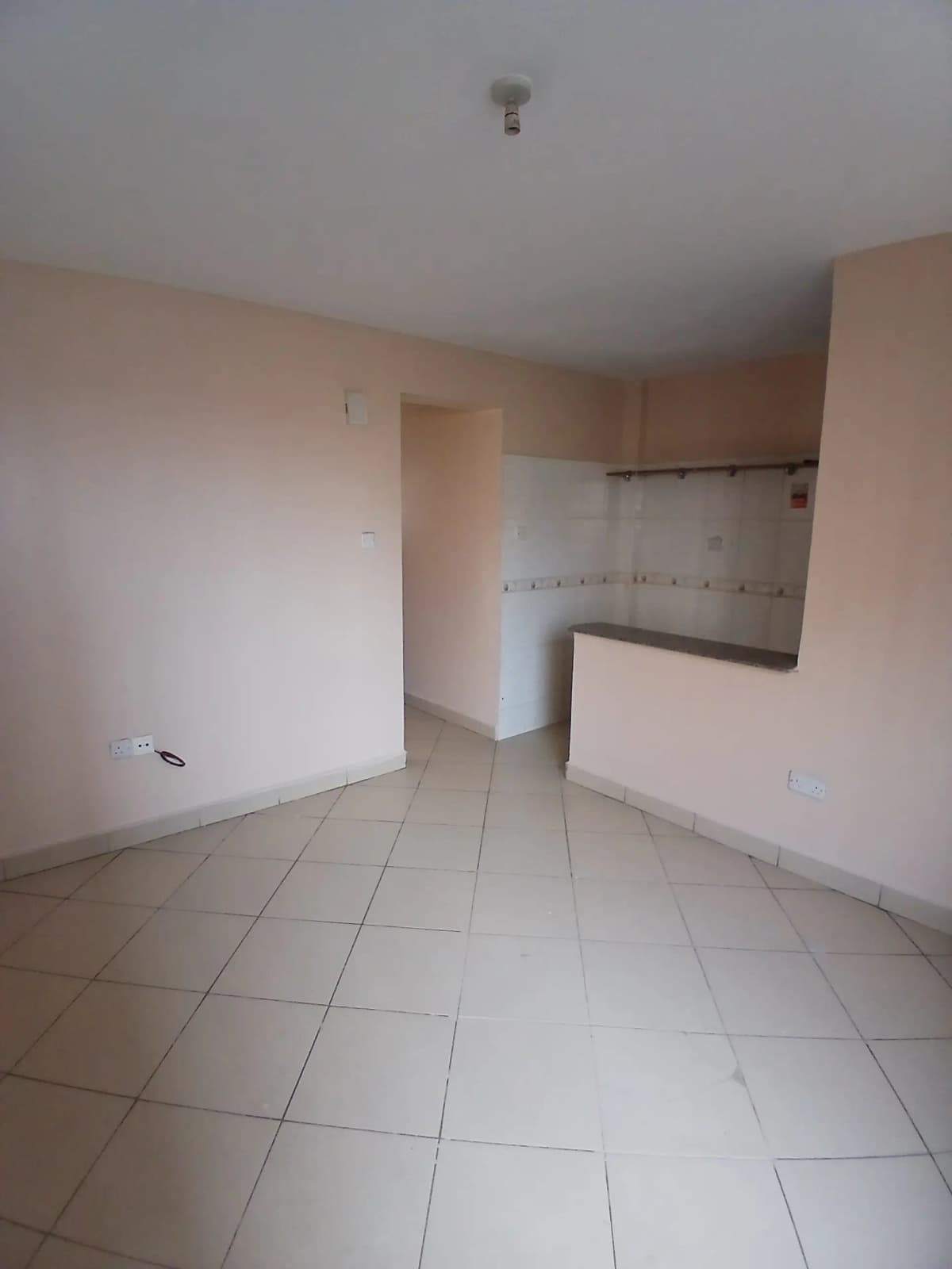 Open-plan kitchen and living area with tile flooring