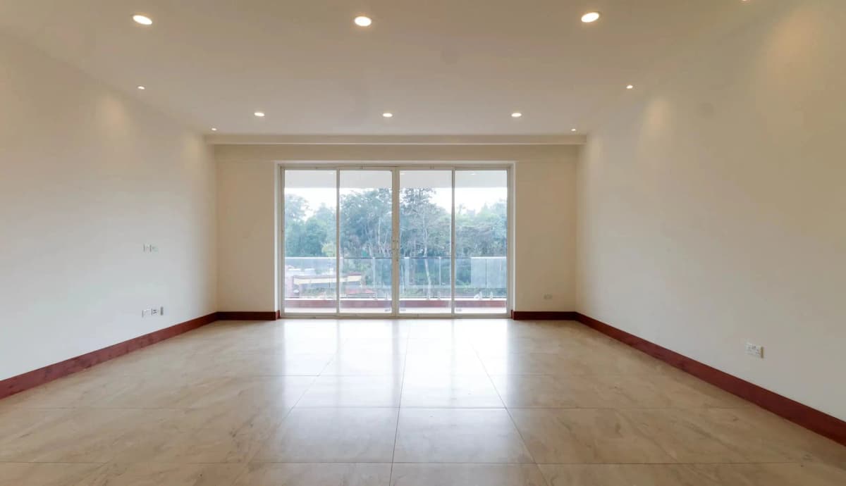 Spacious living room with large sliding glass doors and polished floors