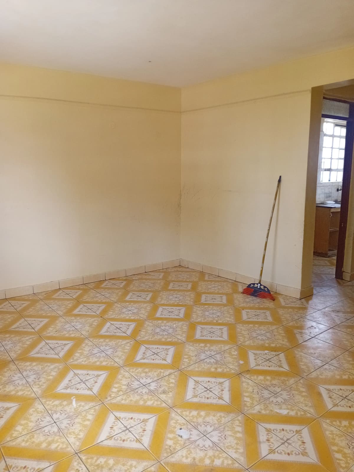Empty bedroom with yellow geometric tile flooring