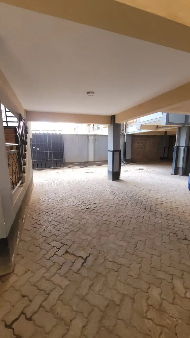Spacious covered parking area with herringbone paving