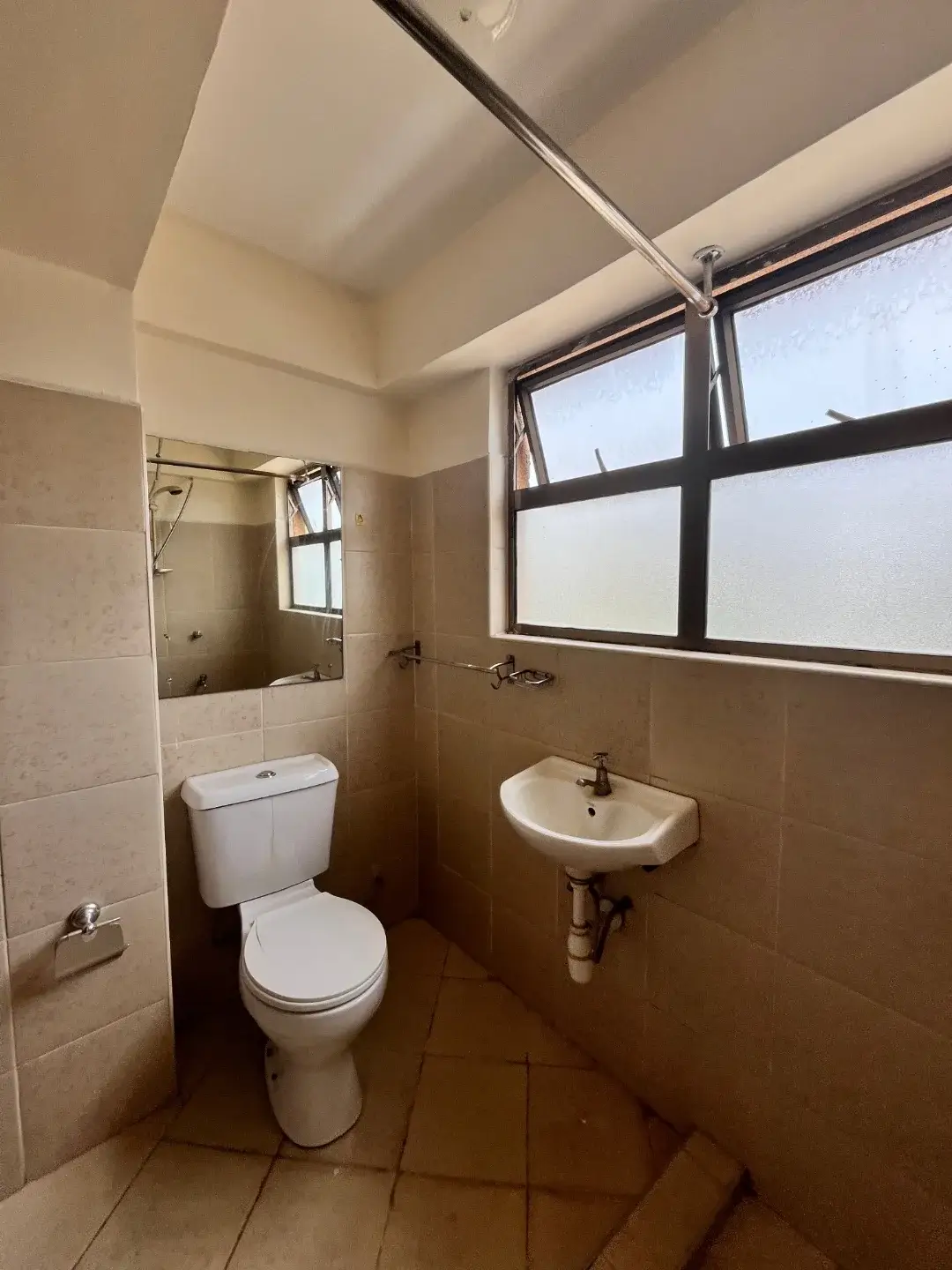 Simple bathroom with toilet, pedestal sink, shower cubicle