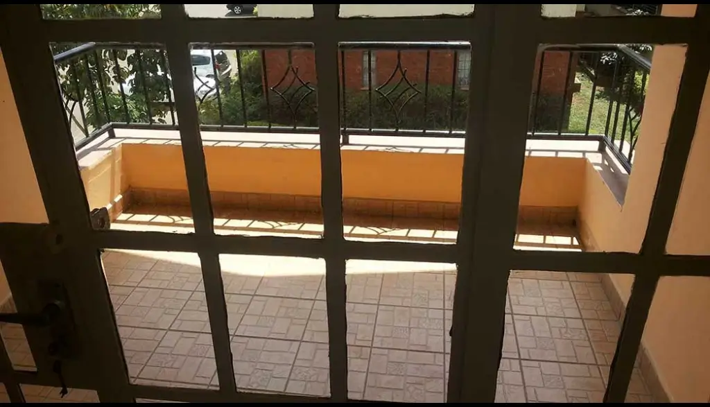 Spacious balcony with terracotta walls and tiled flooring