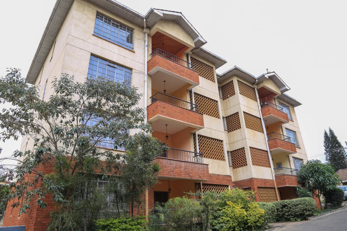 Multi-story residential building with red brick and cream facade