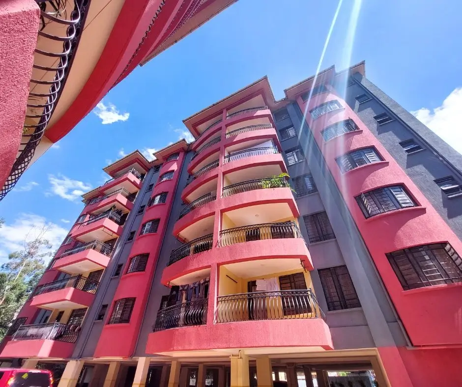 Modern multi-story residential building with pink and purple facade