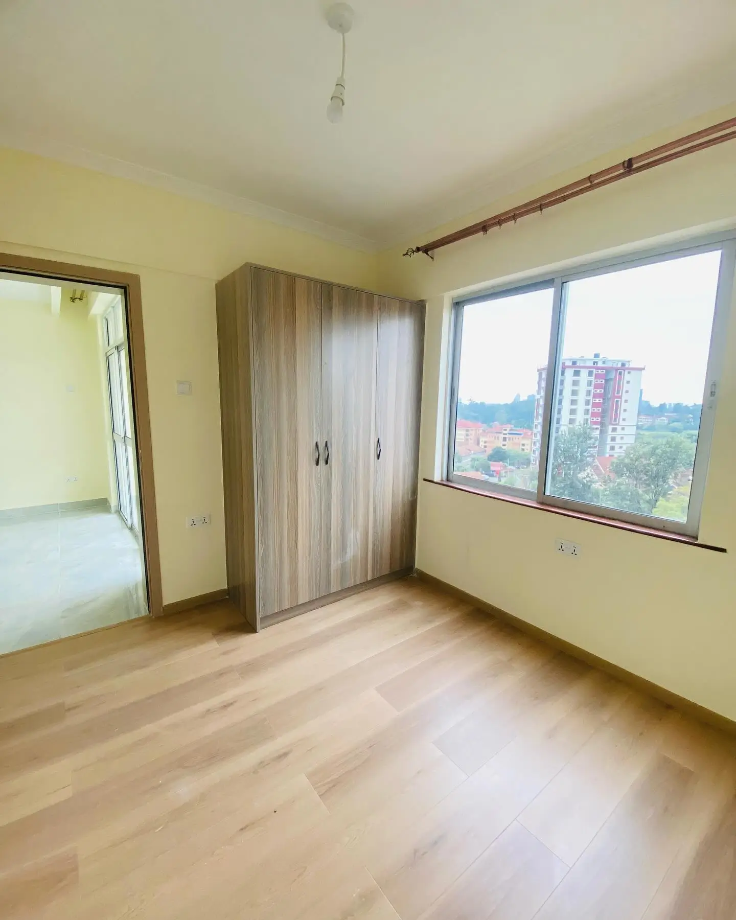 Bright bedroom with wardrobe and panoramic city views