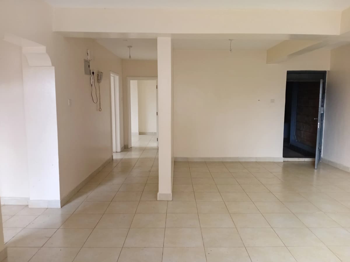 Spacious open-plan living area with tiled flooring and pillars