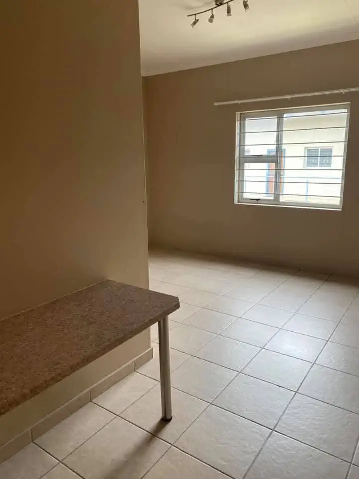 Spacious living room with tiled flooring and built-in bench seating