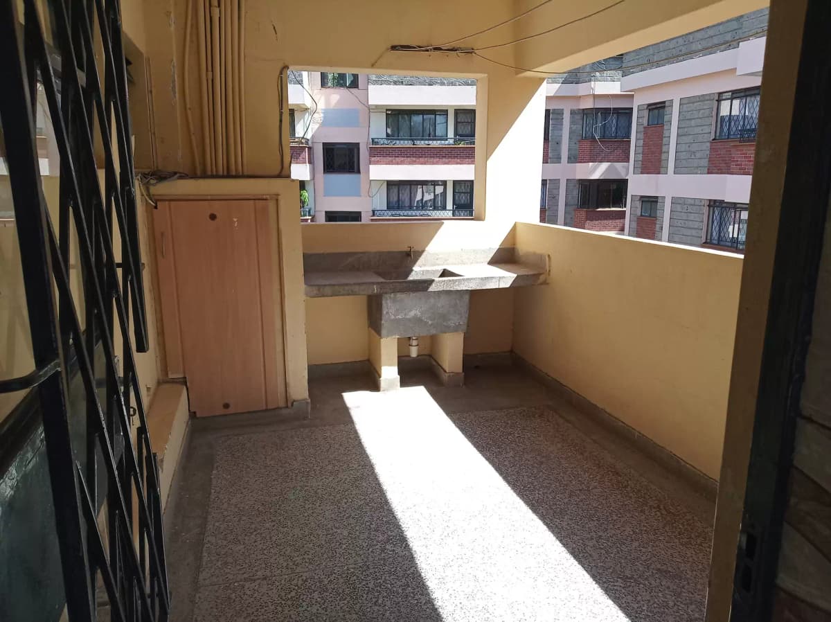 Covered balcony with yellow walls and natural light