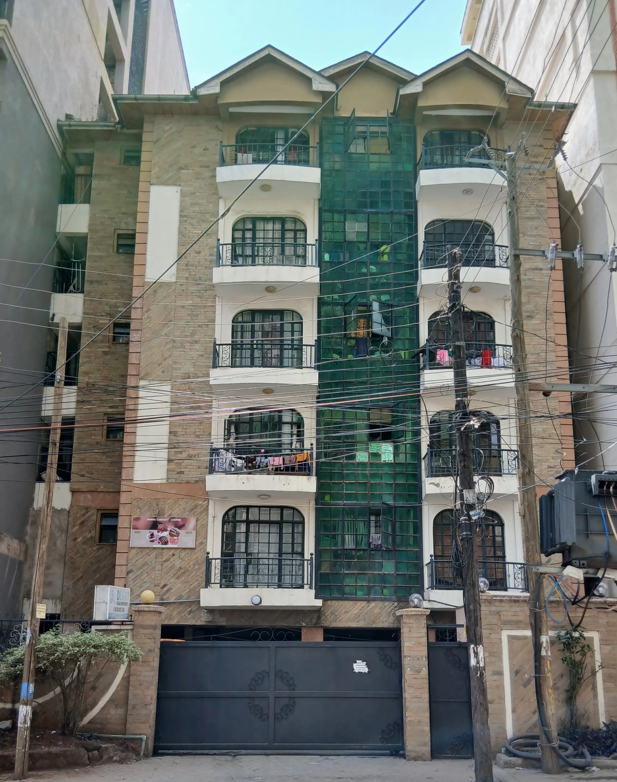 Multi-story residential building facade with brick and tile accents