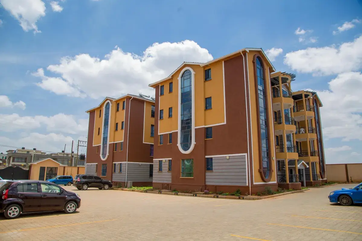 Modern multi-story residential building with brown and gold facade