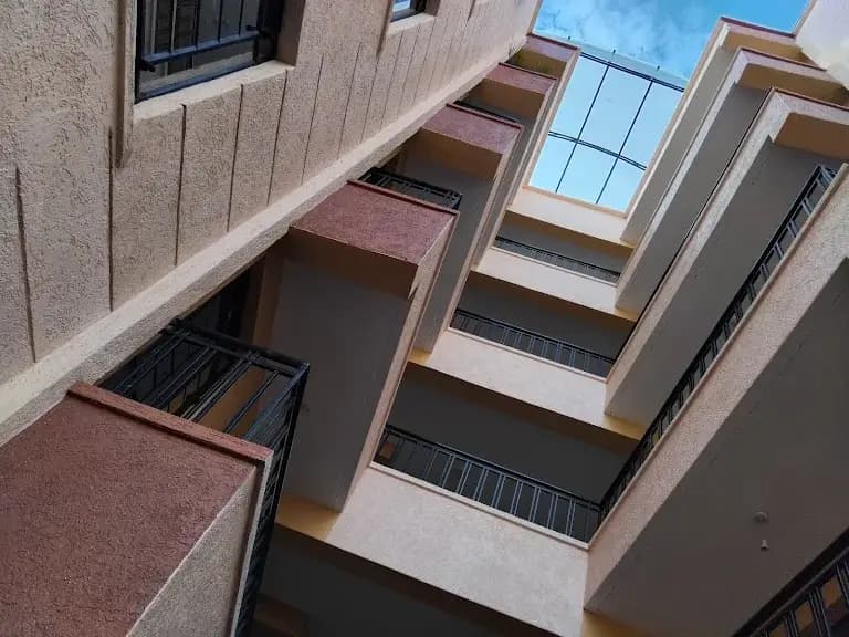 Multi-story residential building facade with balconies and windows