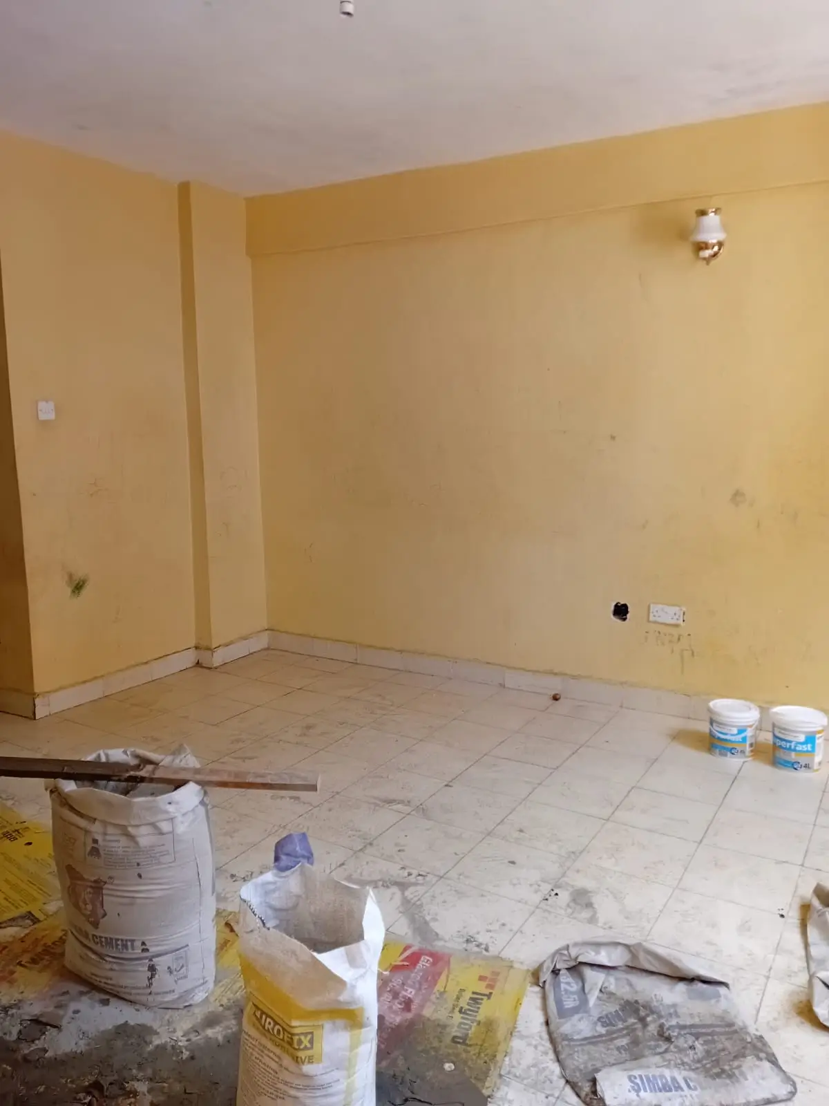 Empty room under renovation with construction materials scattered