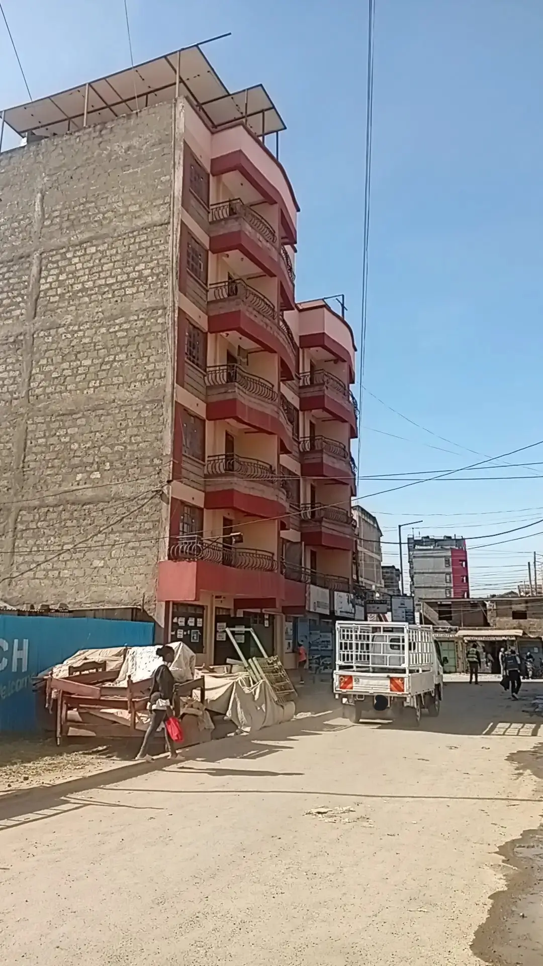 Multi-story residential building facade with red balconies
