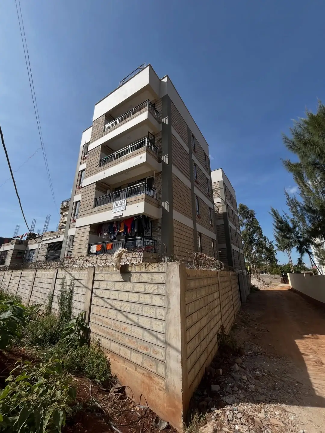 Modern multi-story residential building with concrete facade and balconies