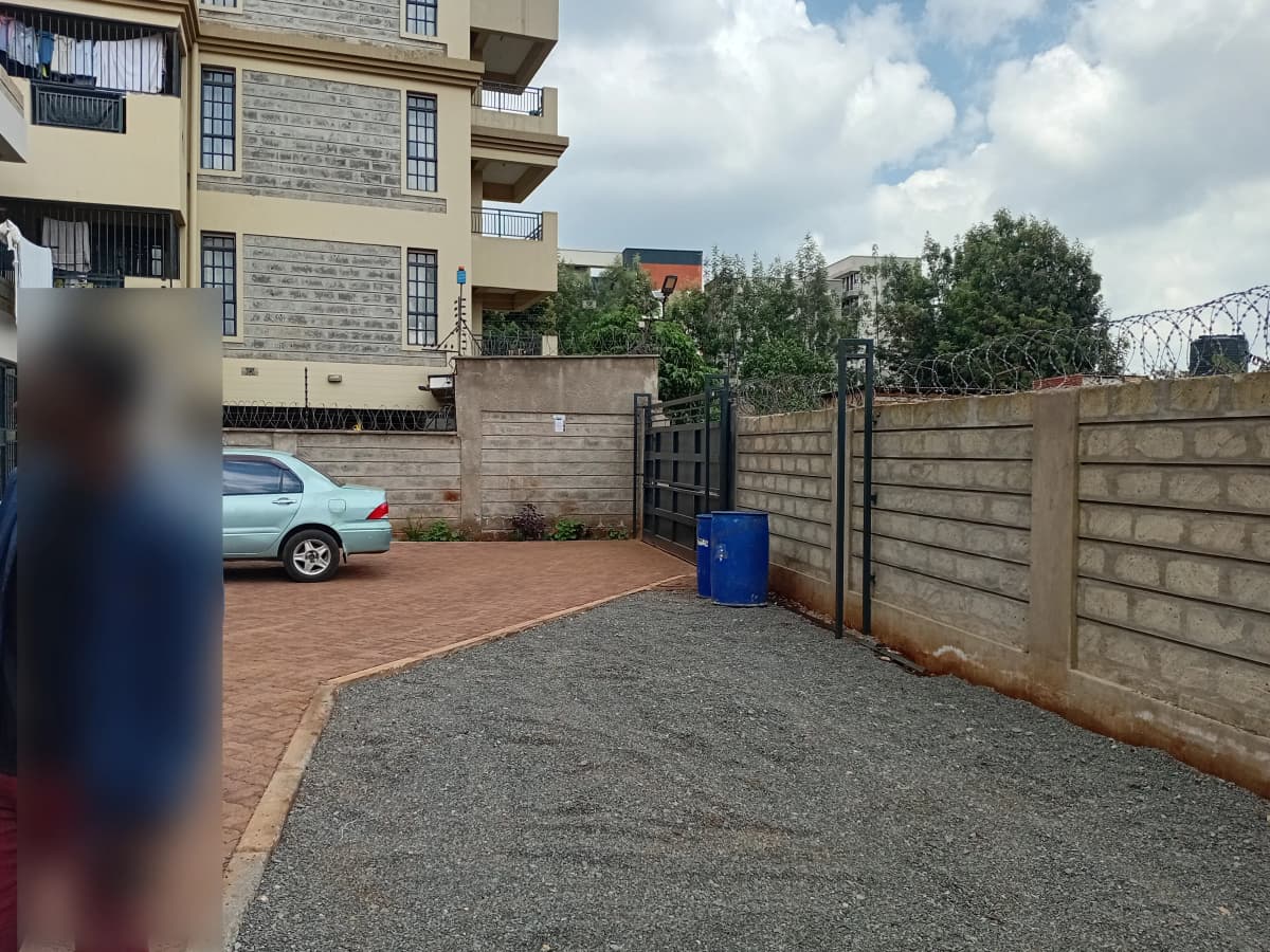 Compound parking area with concrete surface and perimeter walls