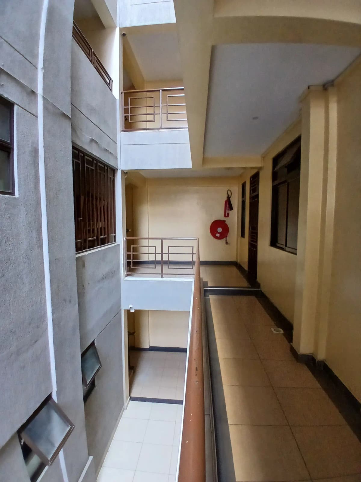 Multi-story building corridor with skylight and fire extinguisher