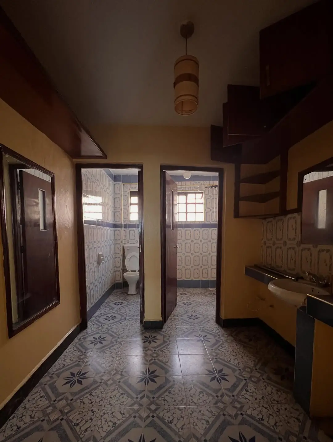 Kitchen with patterned floor tiles and multiple doorways