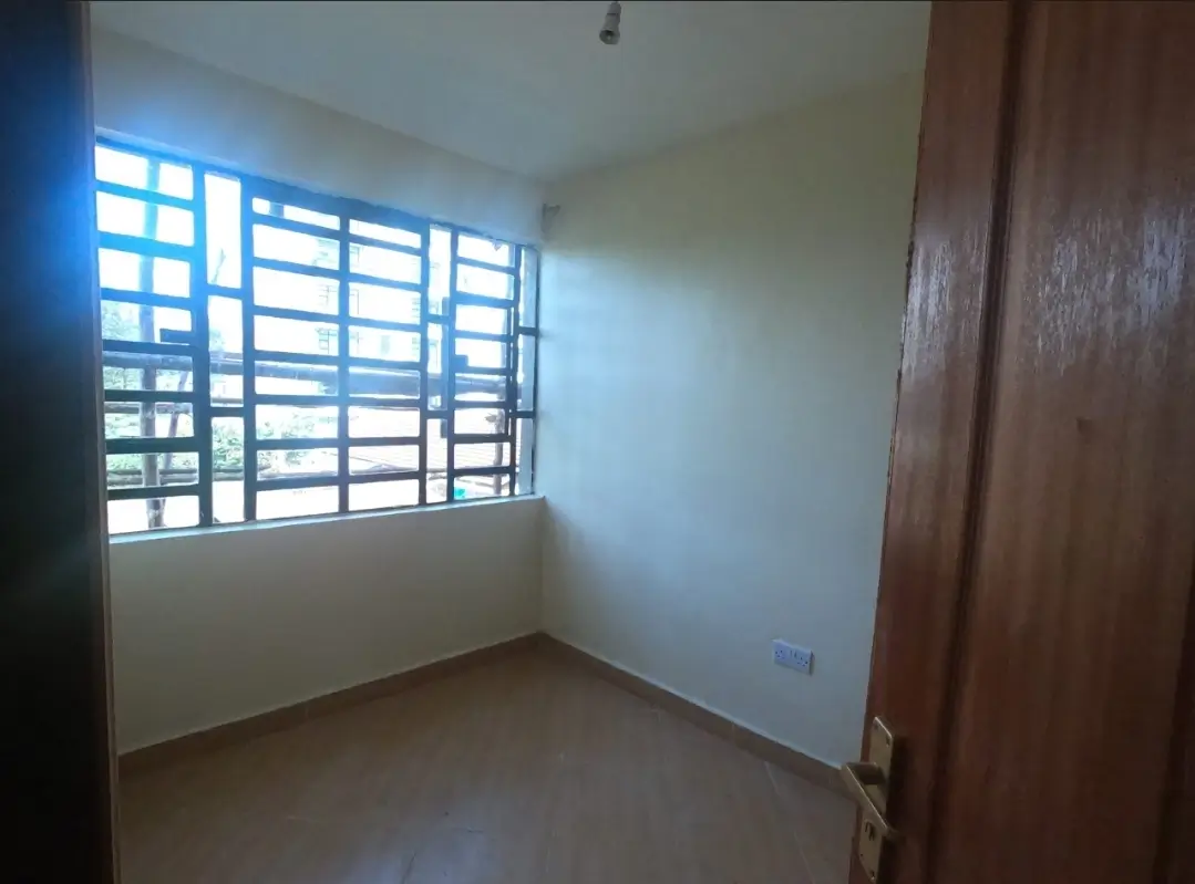 Unfurnished bedroom with louvered window, natural light