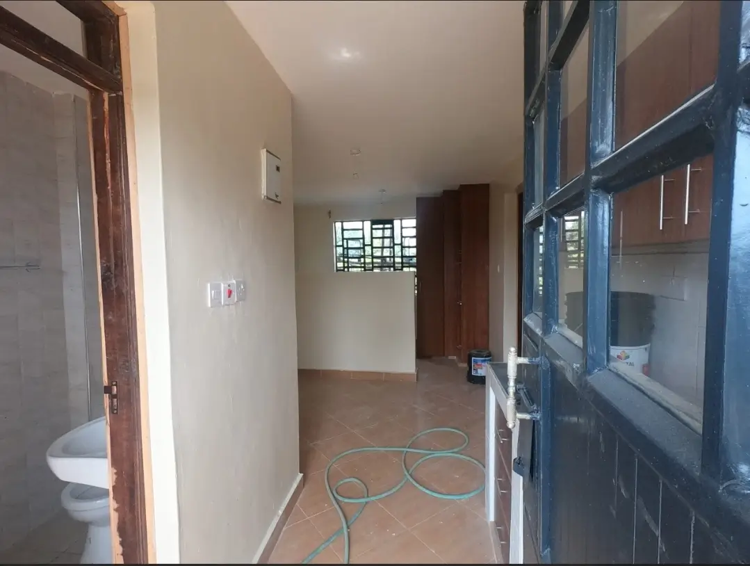 Corridor with bathroom entrance and security gate access