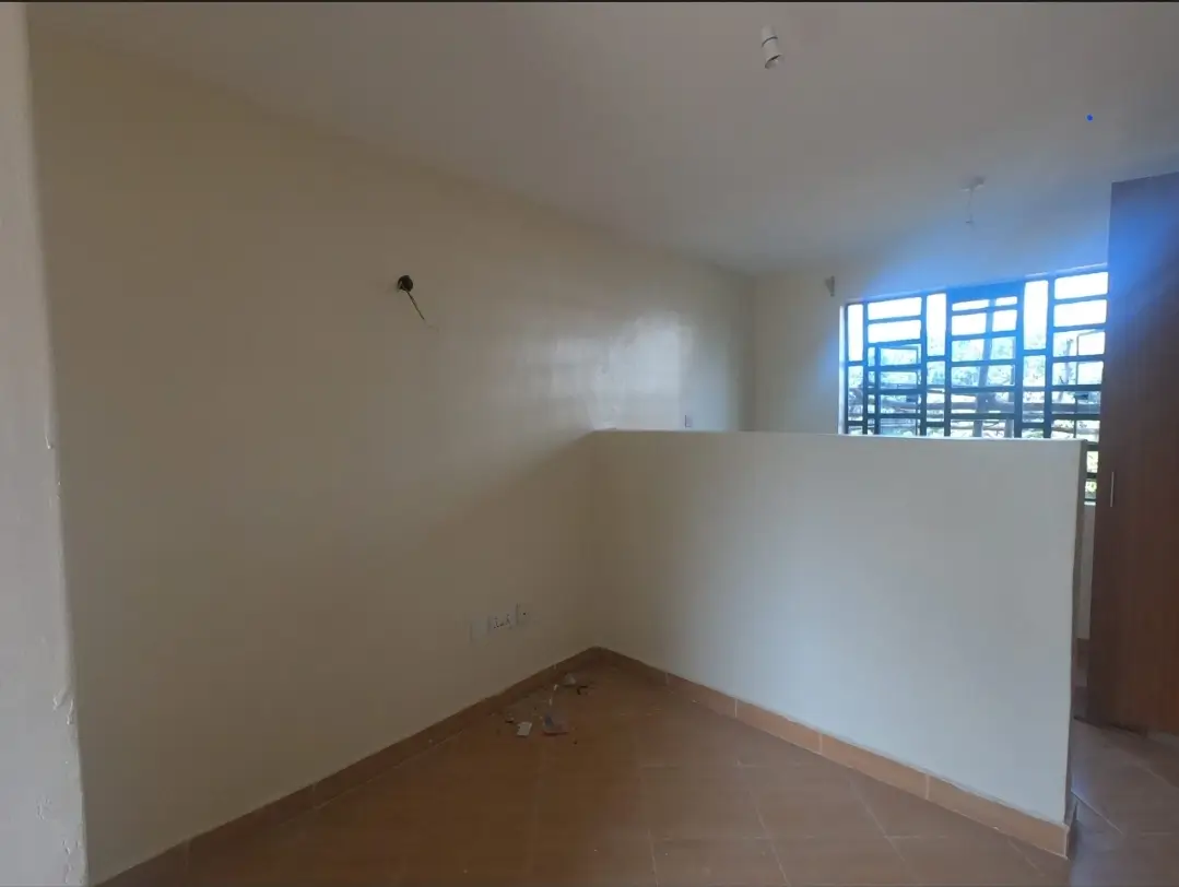 Empty bedroom with natural light from louvered windows