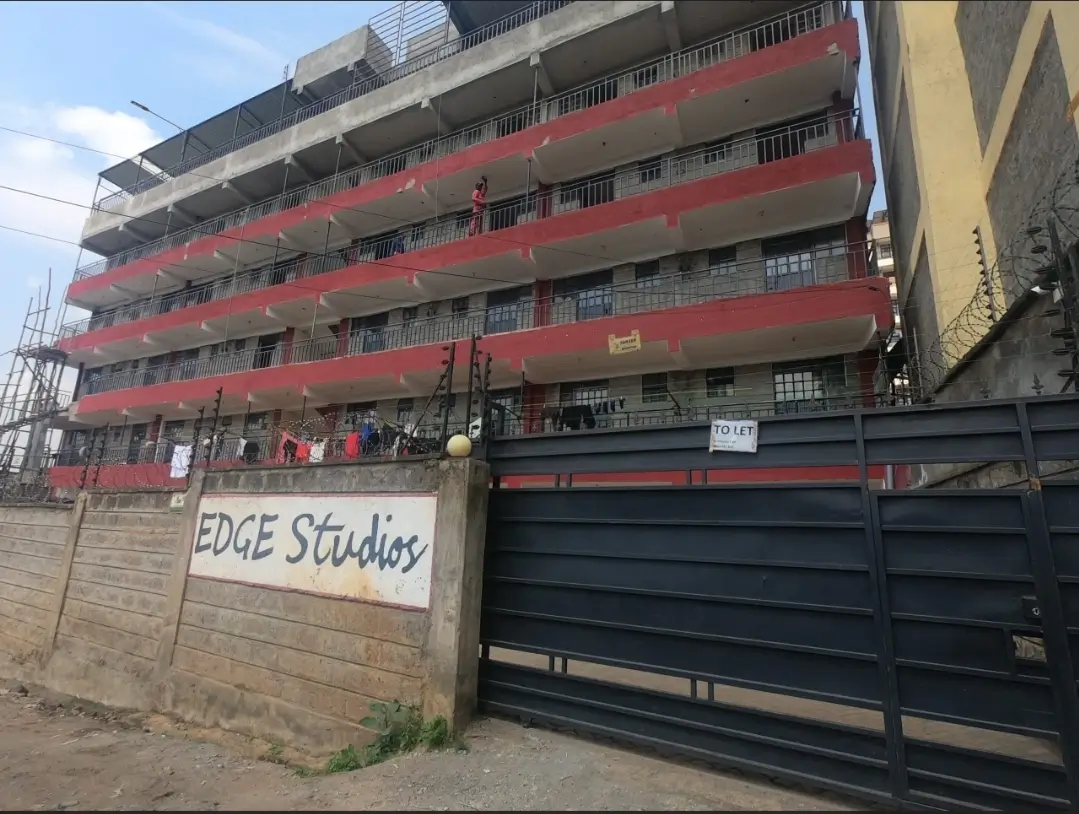 Multi-story residential building with red and black facade