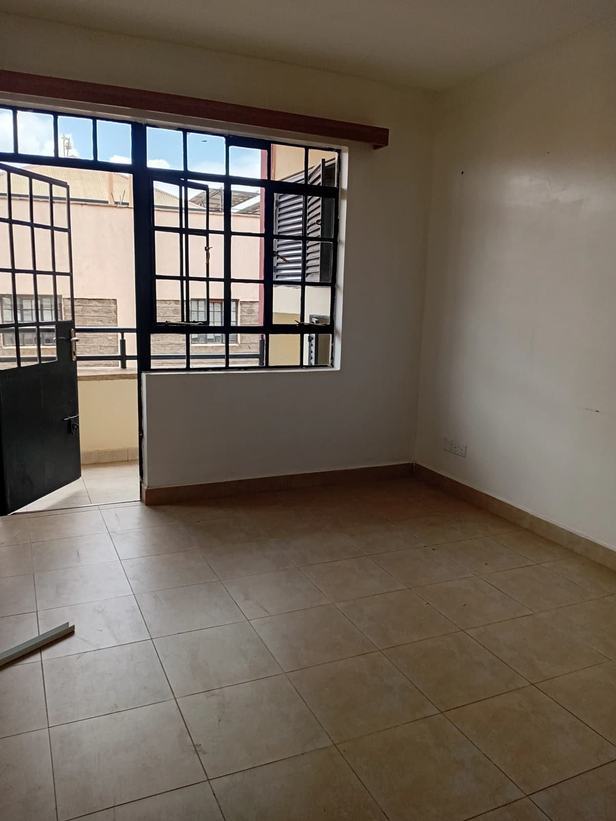 Spacious living room with tiled floor and large windows