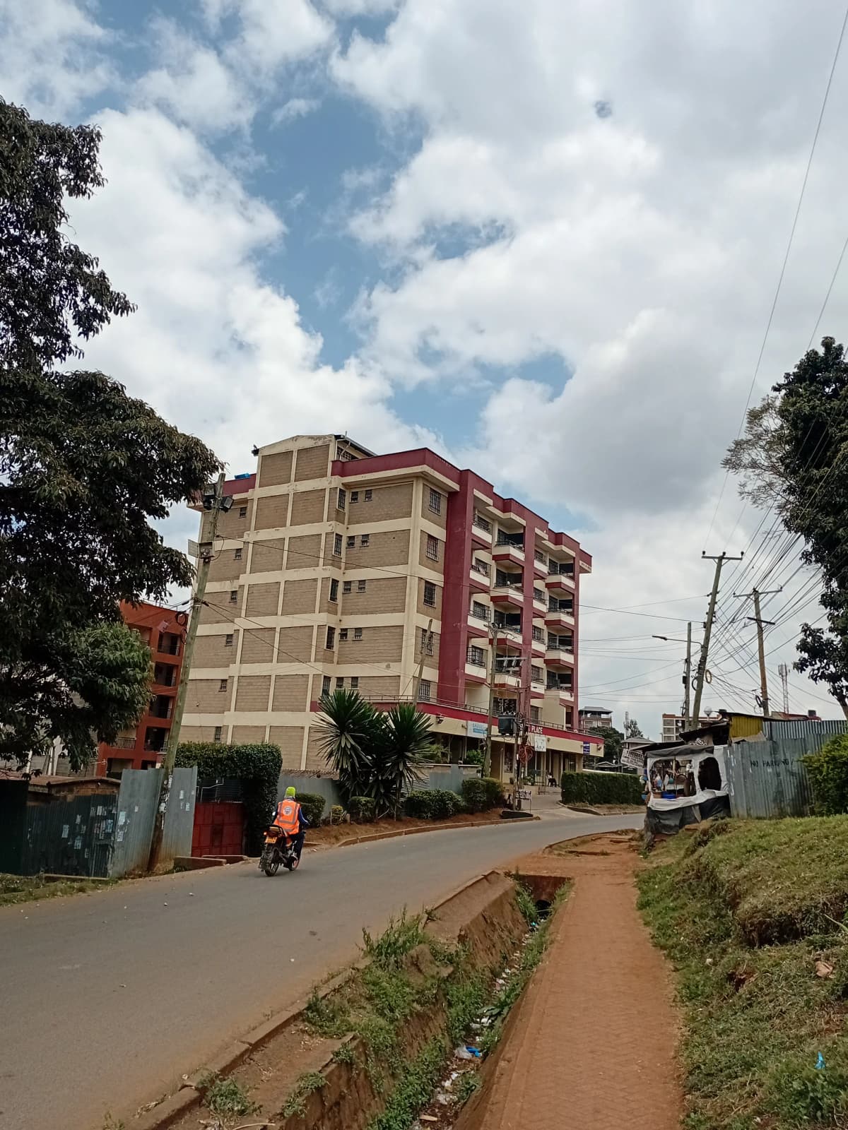 Multi-story residential building with red and cream facade
