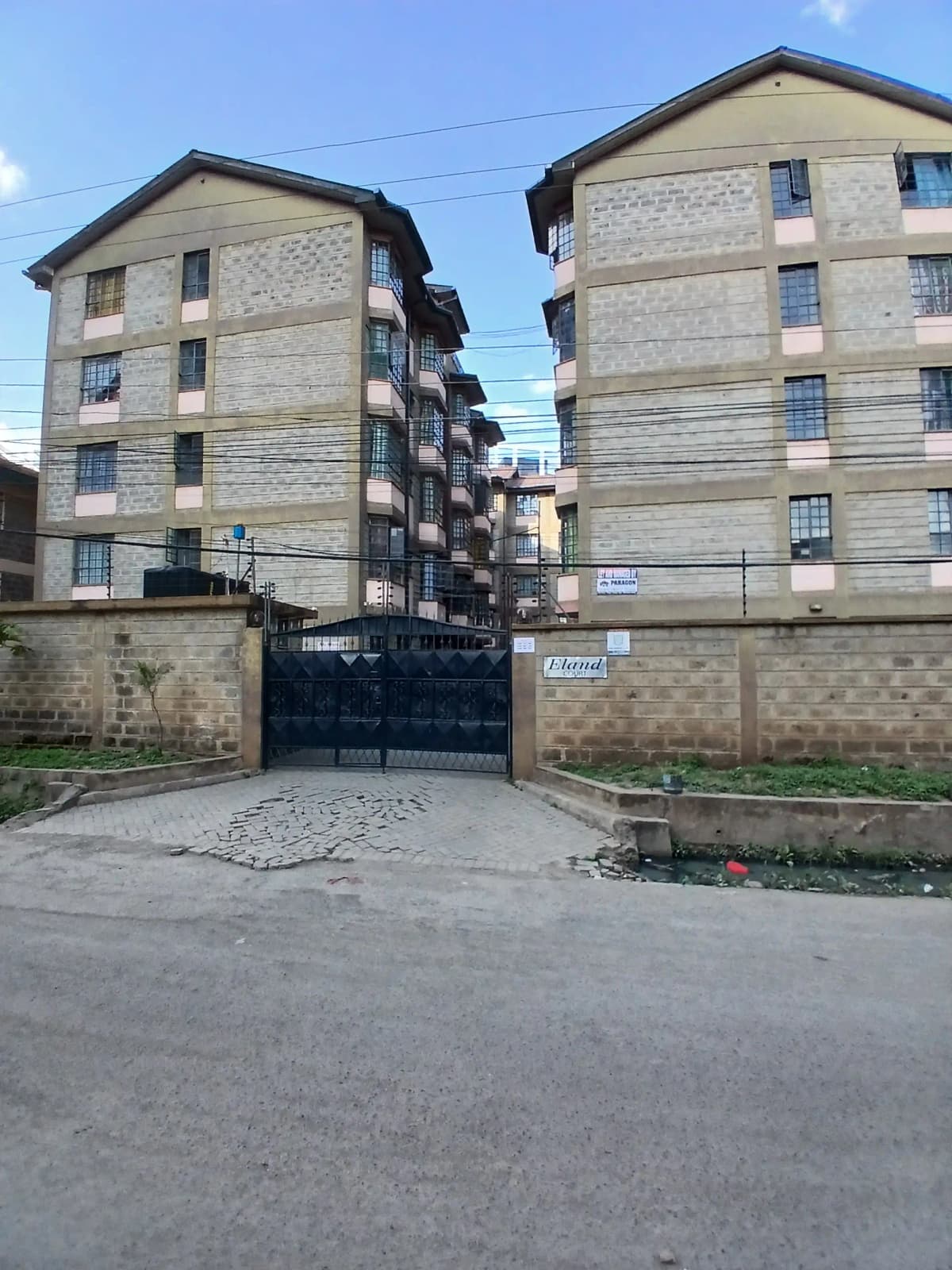 Multi-story residential apartment blocks with perimeter wall gate